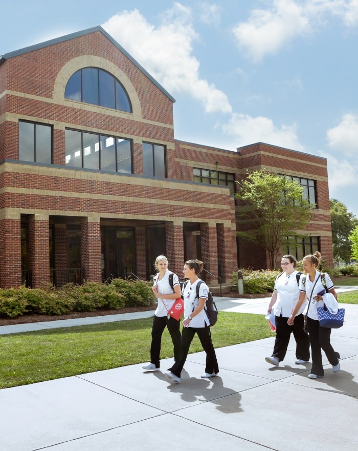 Nursing students walking in front of Oak Hall at MGA's Warner Robins campus